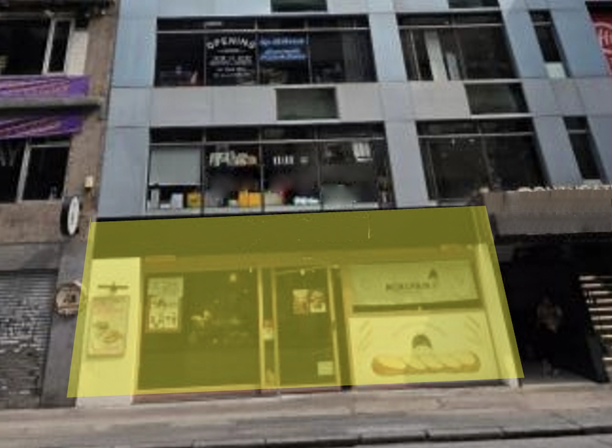 Multi-story building on Granville Road in Tsim Sha Tsui with a yellow-accented facade and restaurant entrance.
