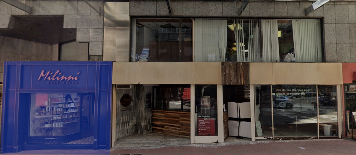 Street view on Queen’s Road Central showing Miliani Hair Shop and a beige storefront with glass windows in Sheung Wan.