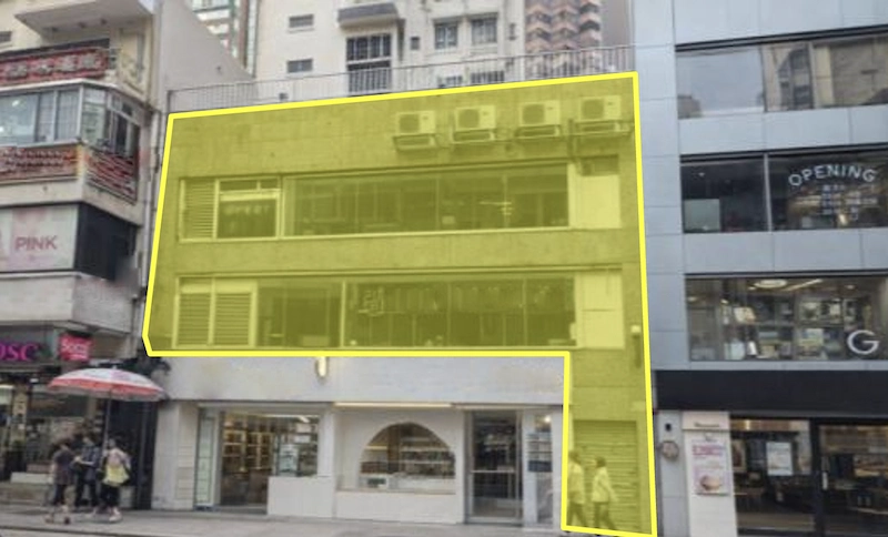 Restaurant space on Granville Road, Tsim Sha Tsui. Three-story concrete building with yellow accents and ground-floor shops.