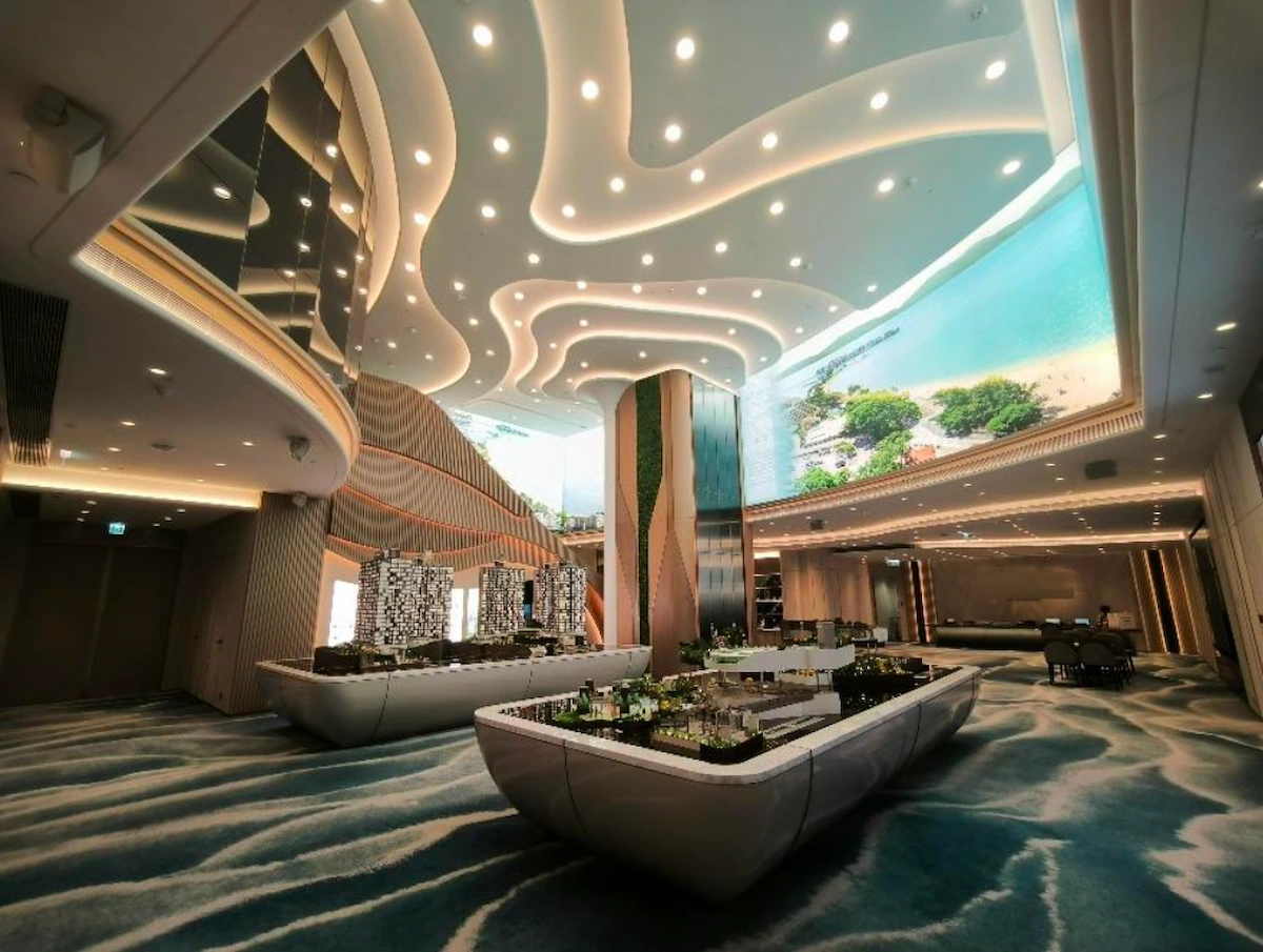 Lobby on Mody Road, Tsim Sha Tsui, featuring curved ceiling lights and architectural models on display tables.