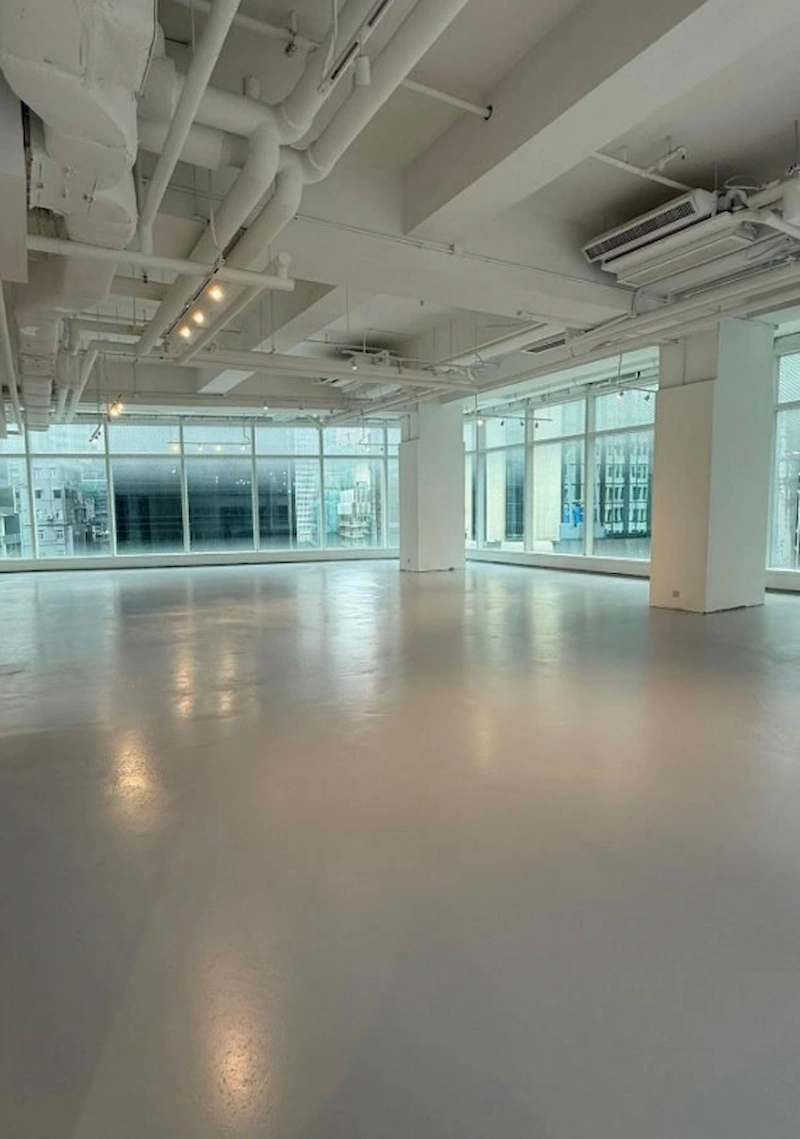 Shop on Queen's Road Central, Central. Modern office space with large windows, white walls, and polished floors on Queen’s Road Central.