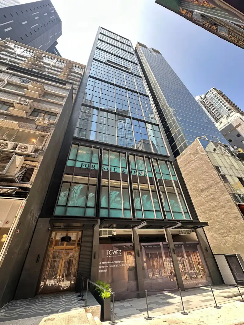 Restaurant space on Wellington Street, Central. Tall modern glass building, surrounded by other high-rise buildings.