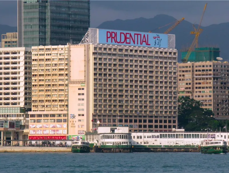 Office on Salisbury Road, Tsim Sha Tsui. A large building with a Prudential sign overlooks Salisbury Road with ferries by the waterfront.