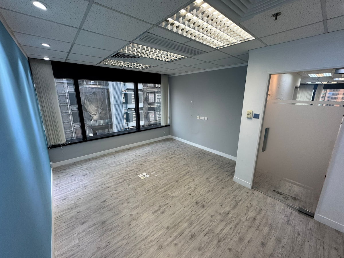 Empty office room with wood flooring, large windows, and a glass door on Leighton Road near Causeway Bay.