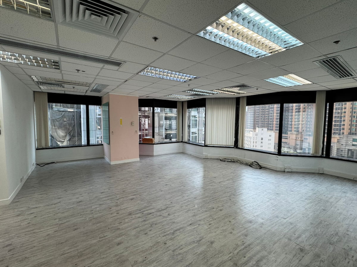 Empty office interior on Leighton Road with large windows, wood-look floors, and city views in Causeway Bay.