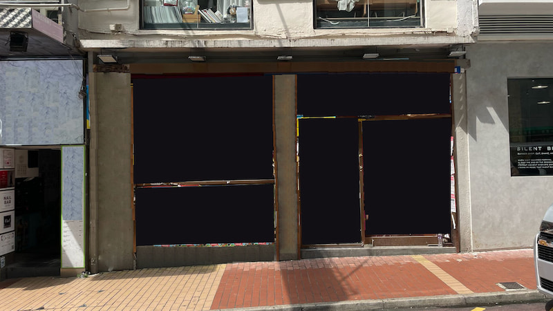 Shop on Lan Fong Road, Causeway Bay. Closed storefront with blacked-out windows and doors during the day.