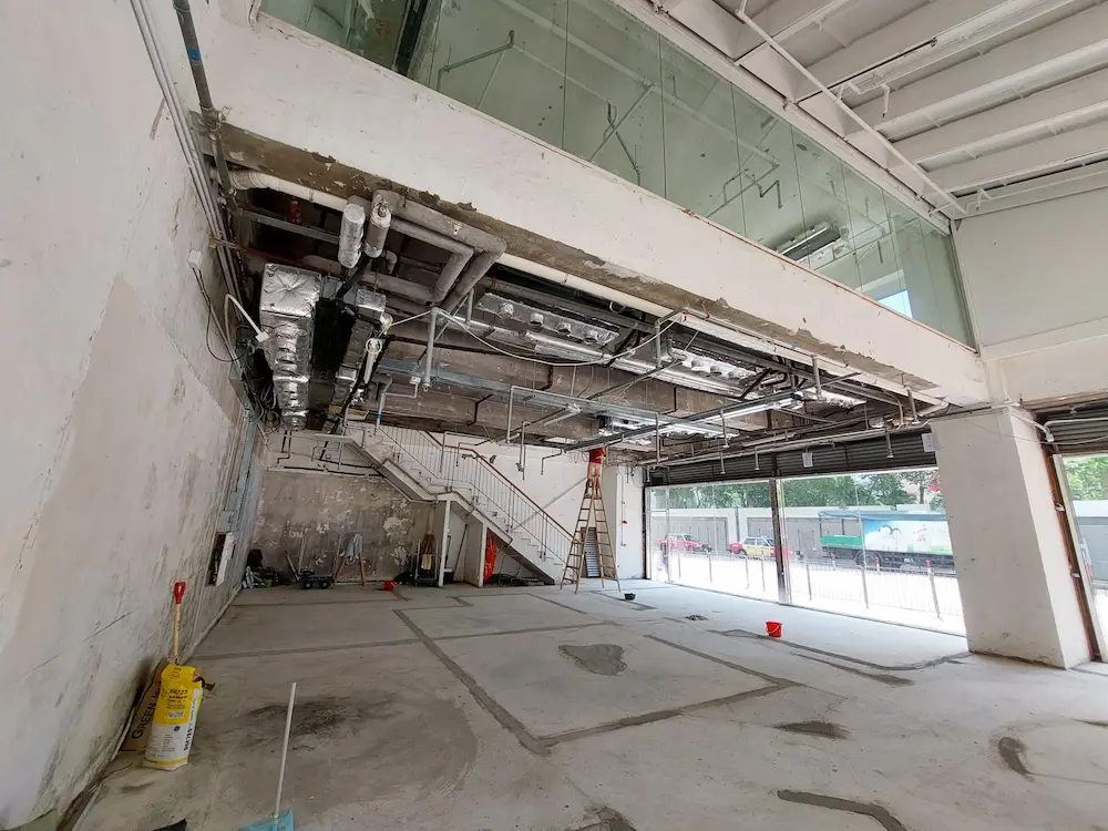 Building interior under construction on Leighton Road, Causeway Bay with exposed pipes, stairs and unfinished floors.