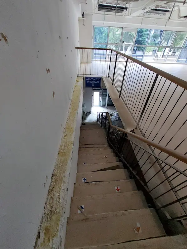 Staircase on Leighton Road in Causeway Bay descending to a door with a blue Welcome to the Show sign above.