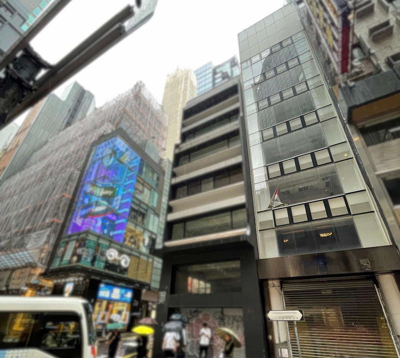 Shop on Wellington Street, Central. A narrow multi-story building on Central Wellington Street is situated between taller structures in a busy urban area.