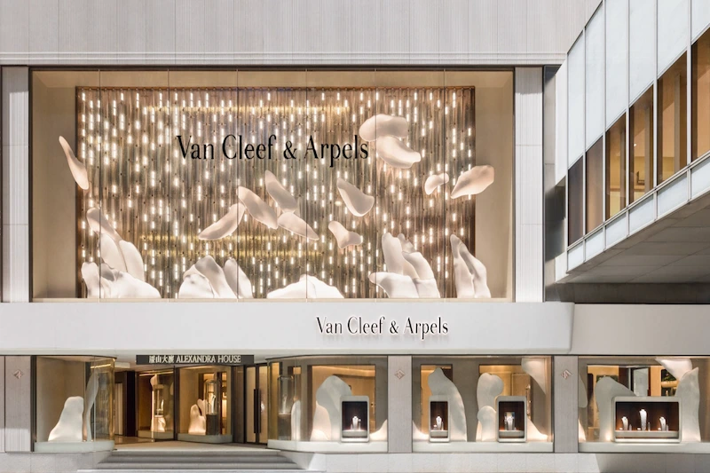Van Cleef & Arpels Hong Kong Maison at Alexandra House with illuminated art and jewelry window displays.