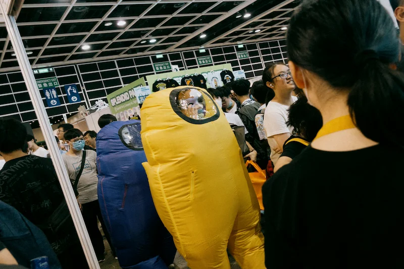 Large crowd attends Ani-Com & Games Hong Kong 2026 as two inflatable sport video game character costumes appear indoors.