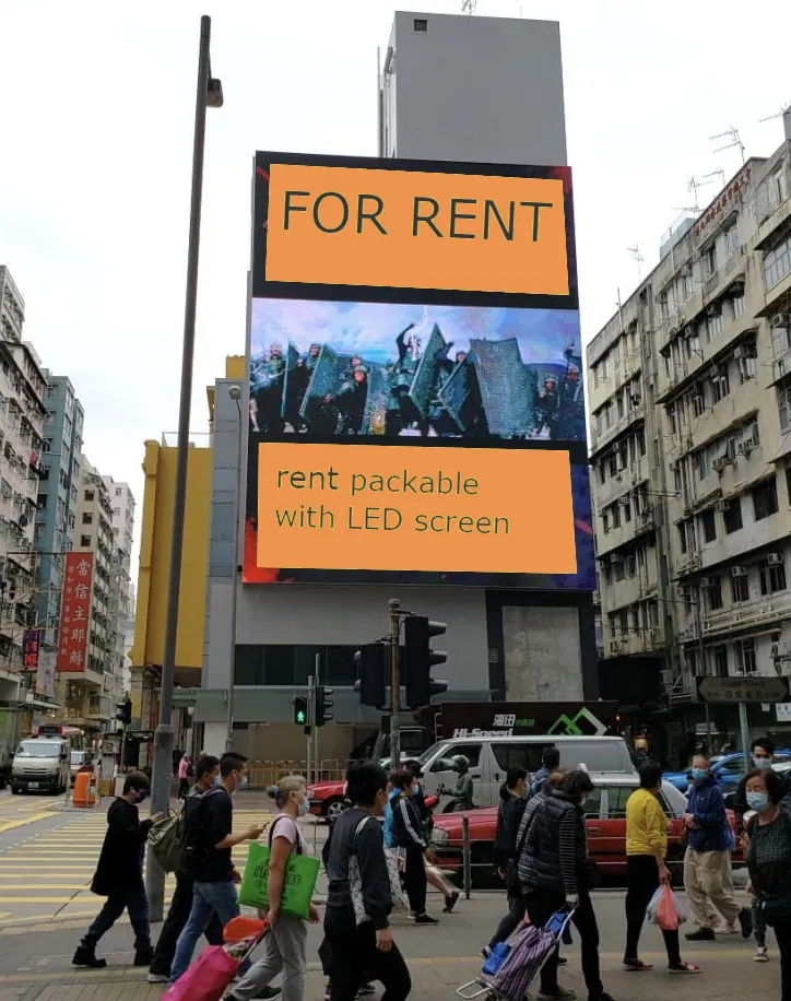 A large LED screen on a city building displays "FOR RENT" and "rent office with LED screen Ref#3505" as pedestrians in masks walk across a busy street lined with tall buildings.