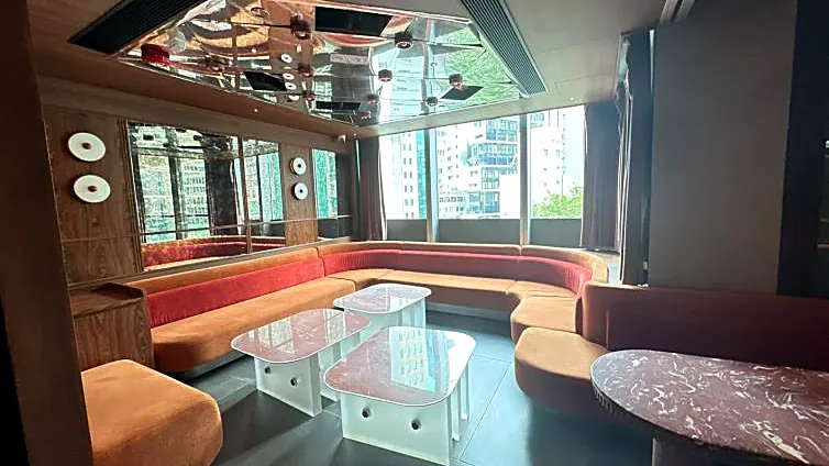 Fitted restaurant at H Code, Central – curved banquette seating under a mirrored ceiling