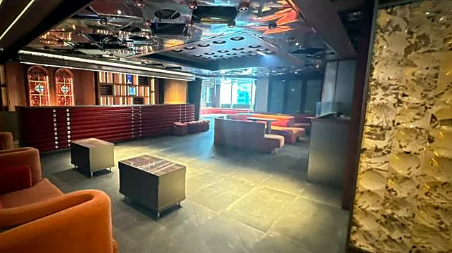 Fitted restaurant at H Code, Central – main lounge with bar counter and feature stone wall
