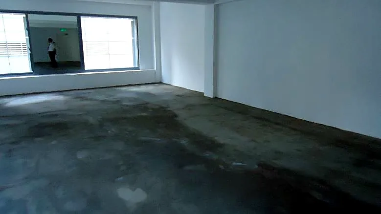 Office at W Place, Central. Open bare-shell floor looking towards the windows.