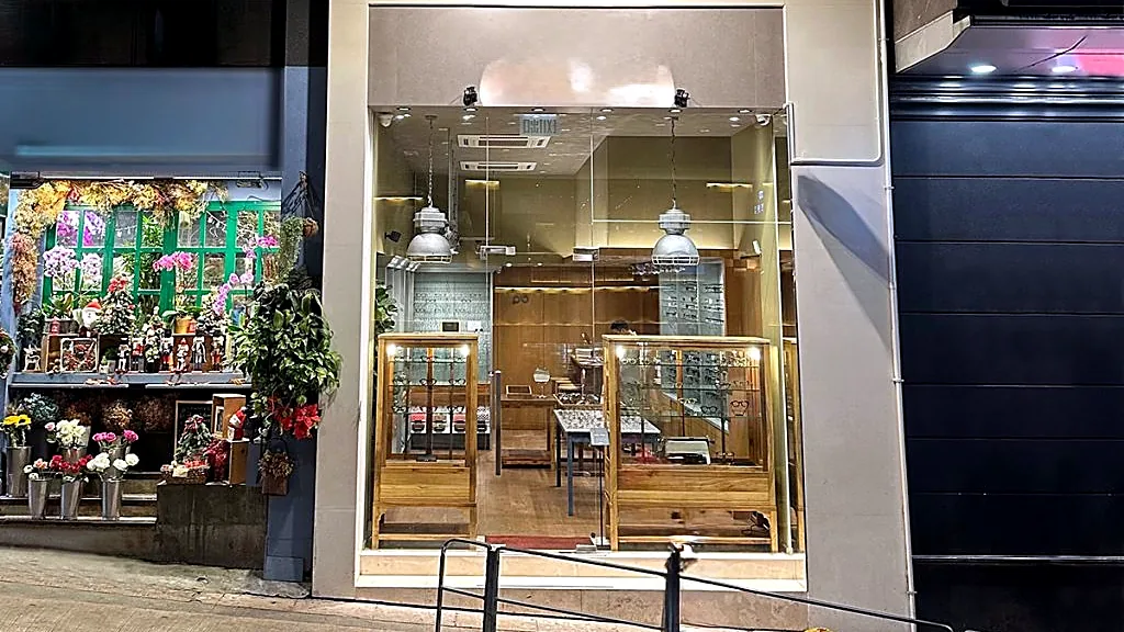 Shop at Duke Wellington House, Central: full-height glass shopfront on Wellington Street at dusk