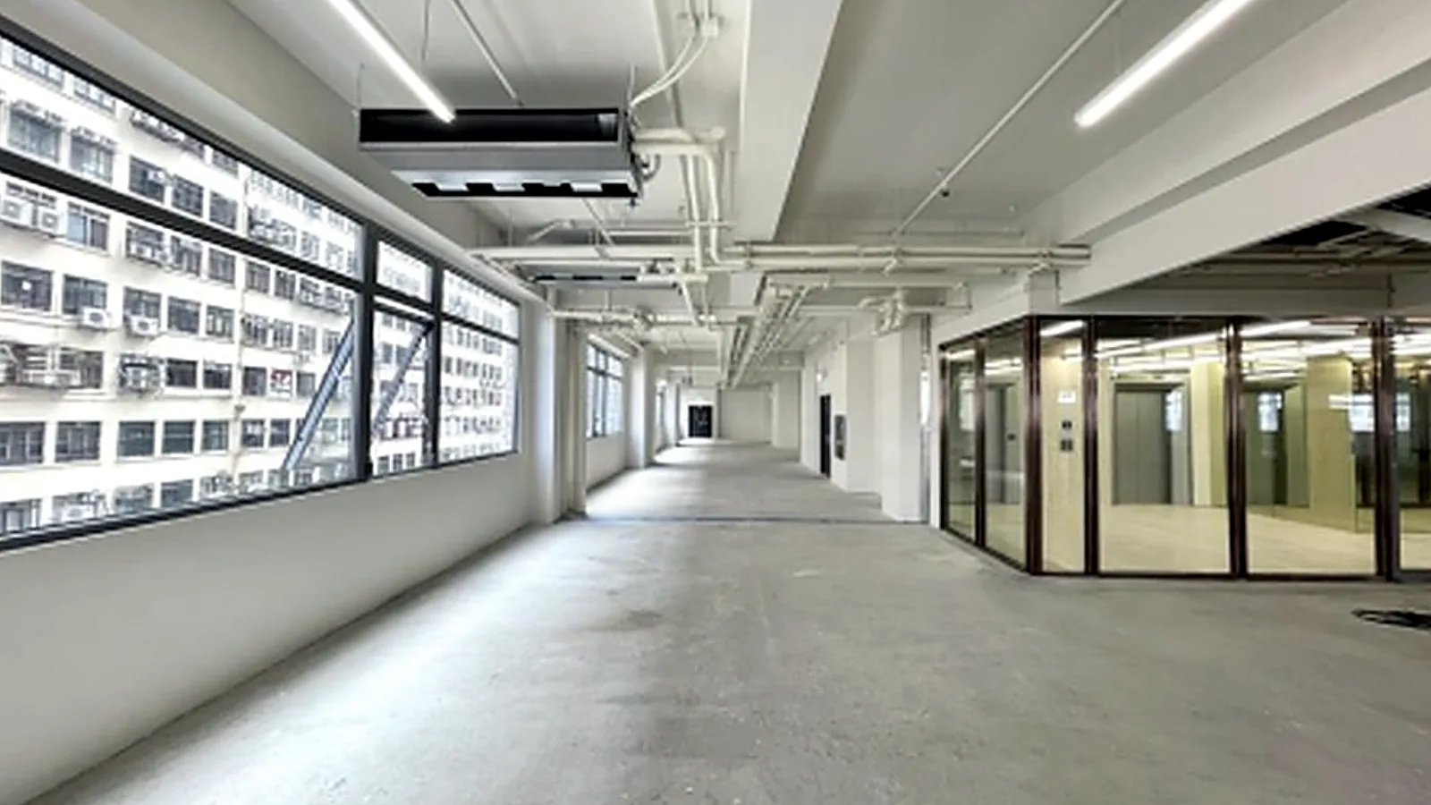 Office at Victoria Centre, North Point – long window-lined floor next to the lift lobby