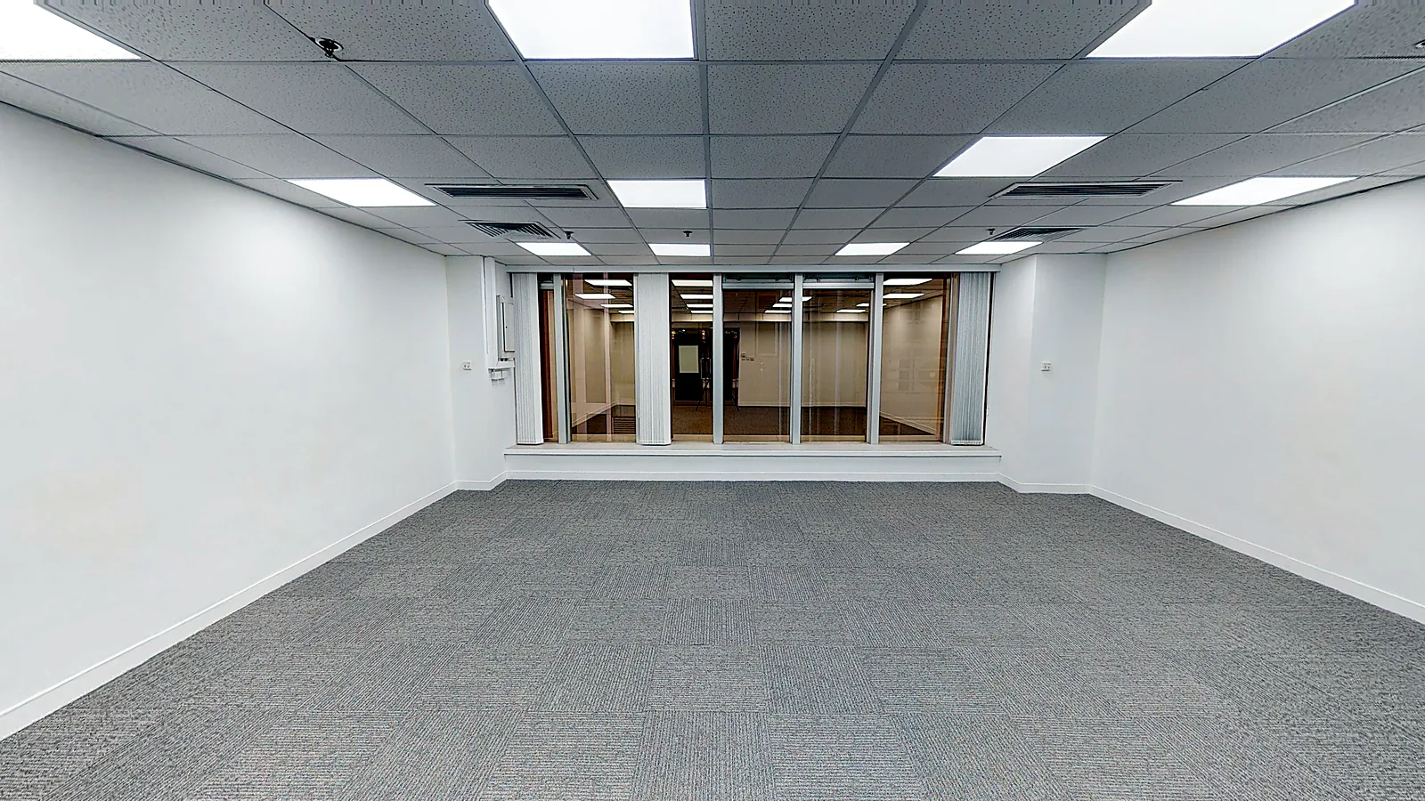 Office at On Hing Building, Central – carpeted office with false ceiling and glass entrance doors