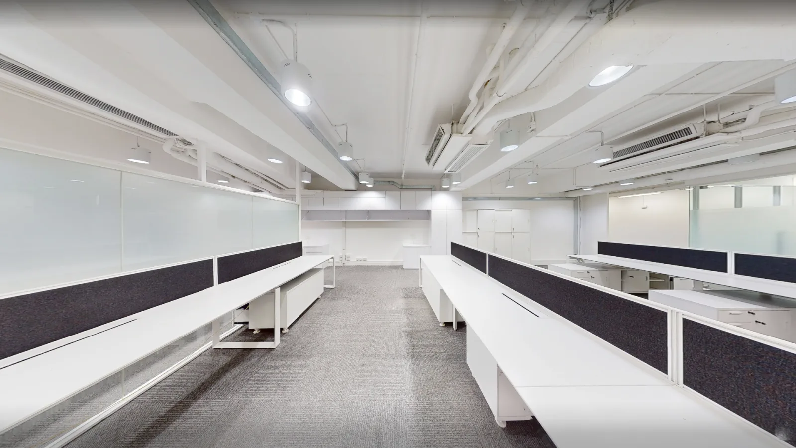 Office at Universal Trade Centre, Central – open-plan workstations along the glass partition