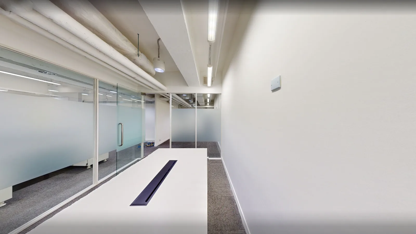 Office at Universal Trade Centre, Central – long work table and glass partitions