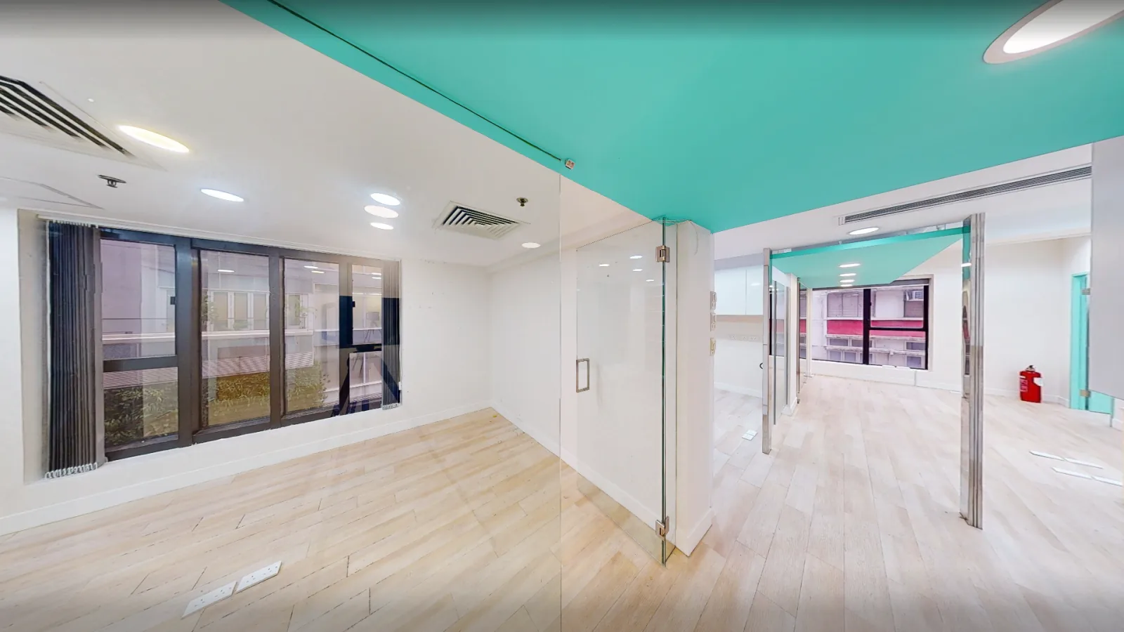 Office at World Trust Tower, Central – open floor with timber flooring and windows