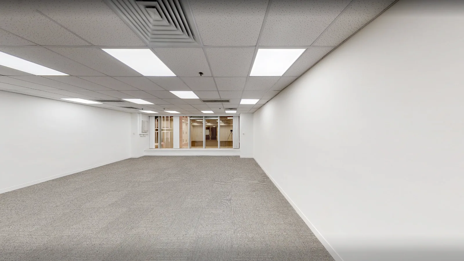 Office at On Hing Building, Central – carpeted open-plan office with false ceiling and windows at the far end