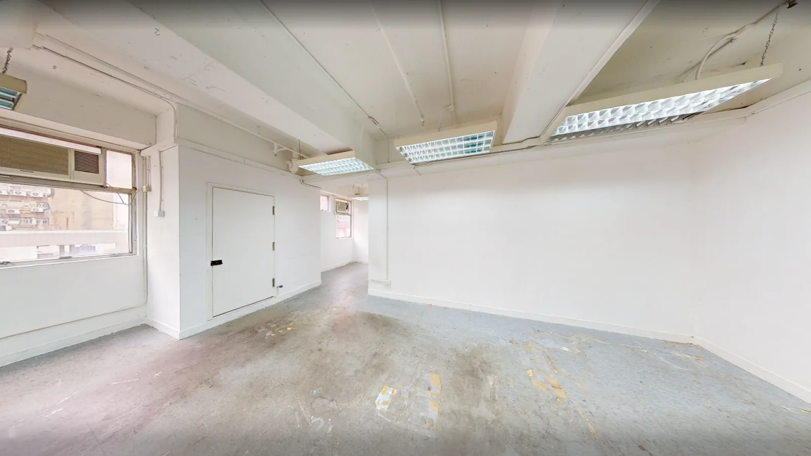 Office at China Trade Centre, Kwun Tong – bare-shell open floor with windows and service door