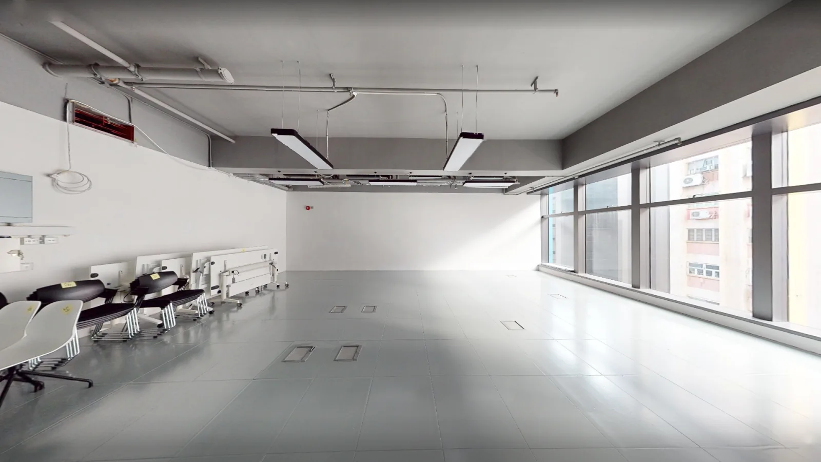 Office at Gravity, Kwun Tong – bare-shell open floor with full-height windows