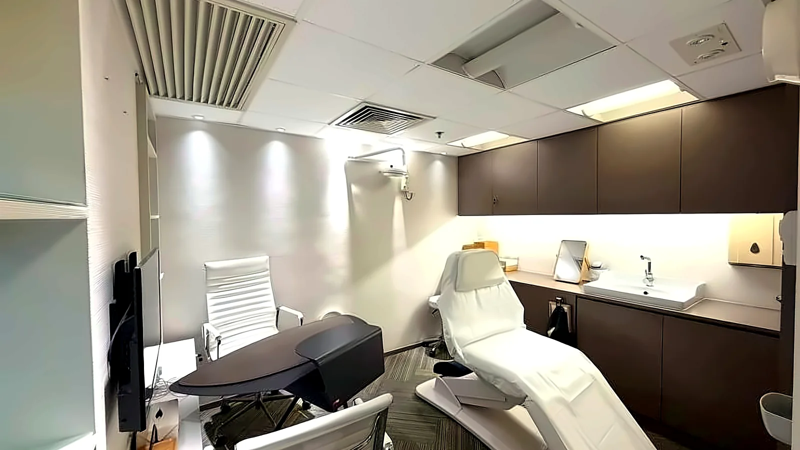 Office at Crawford House, Central – treatment room with cabinetry and basin