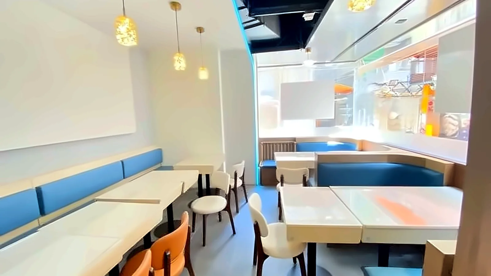 Restaurant dining room at H8, Tsim Sha Tsui with blue booth seating