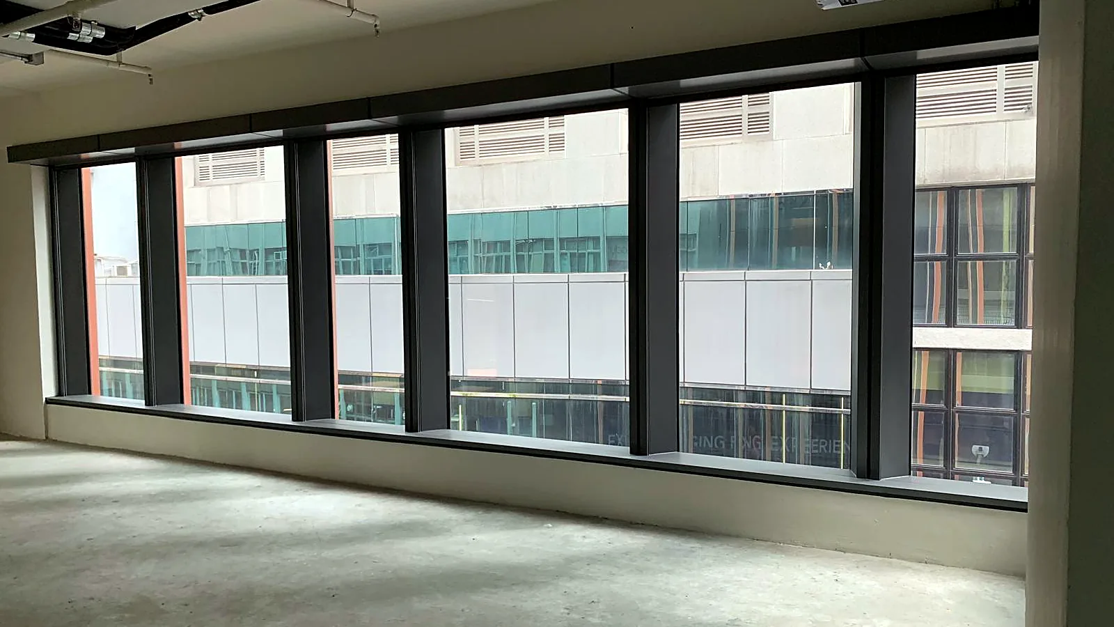 Office for lease in Central on Wellington Street — open bare-shell floor with large windows