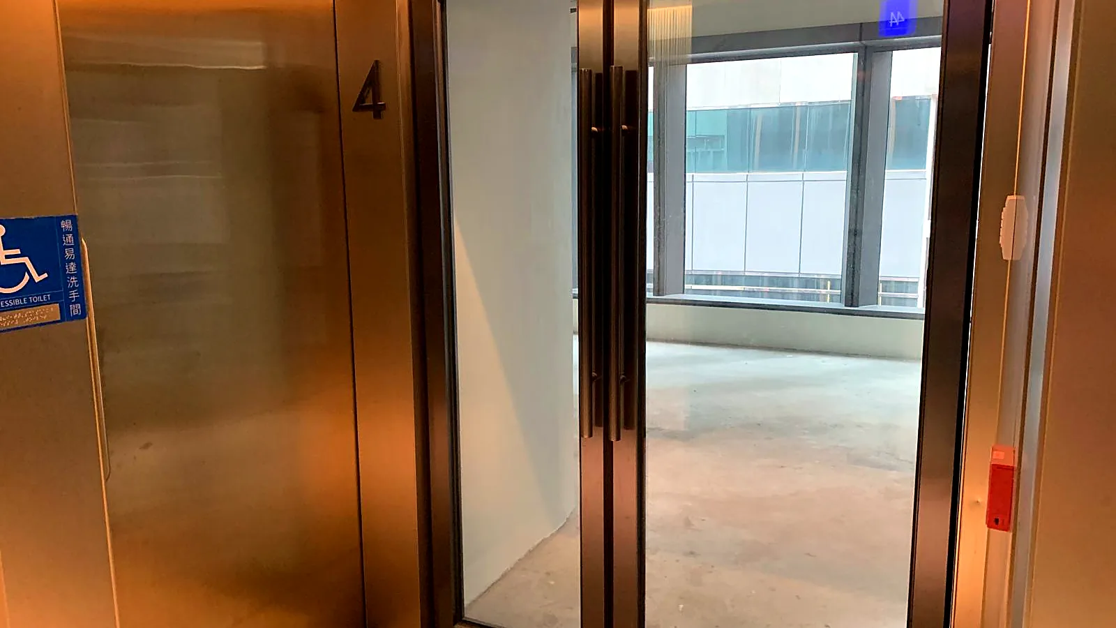 Lift lobby entrance into the bare-shell office on Wellington Street, Central