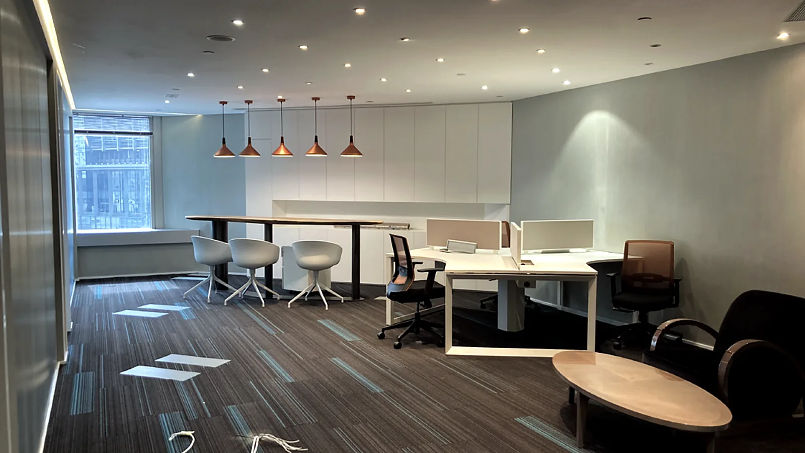 Fitted open-plan office with desks and bar seating at The Center, Central