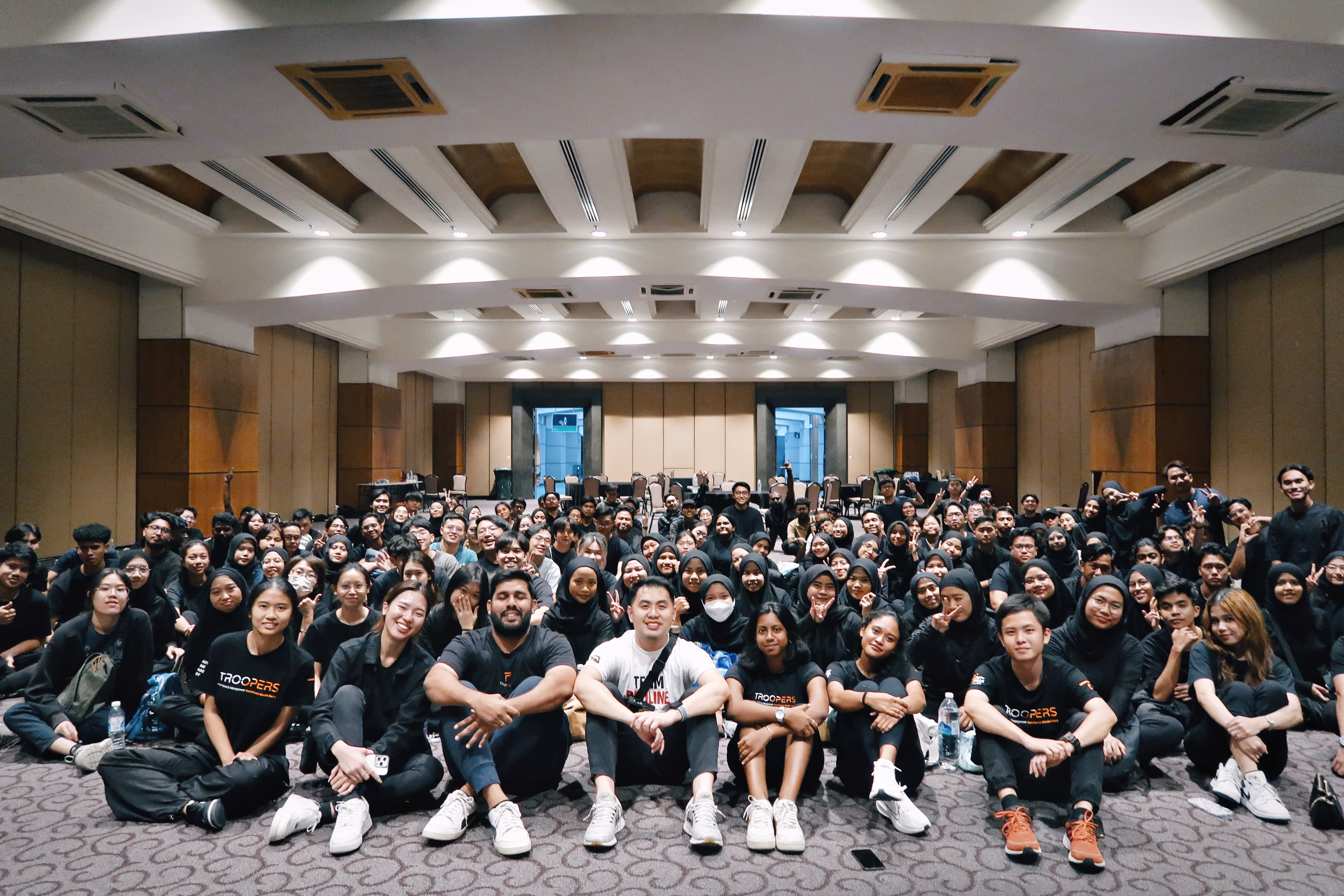 Large group of TROOPERS part-time workers gathered in a hall for a team event, highlighting unity and community spirit among the workforce in Malaysia.