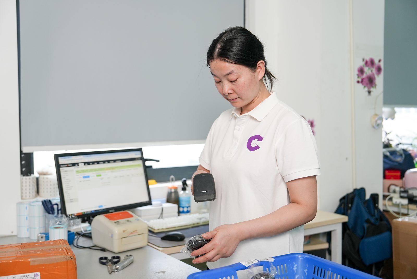 A Commercive team member scanning a parcel at a packing station