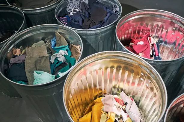 Image of trash cans with clothes in them