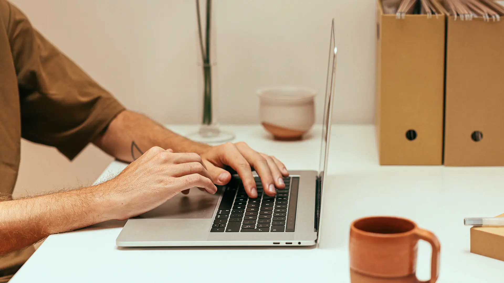 Someone using a laptop at a desk