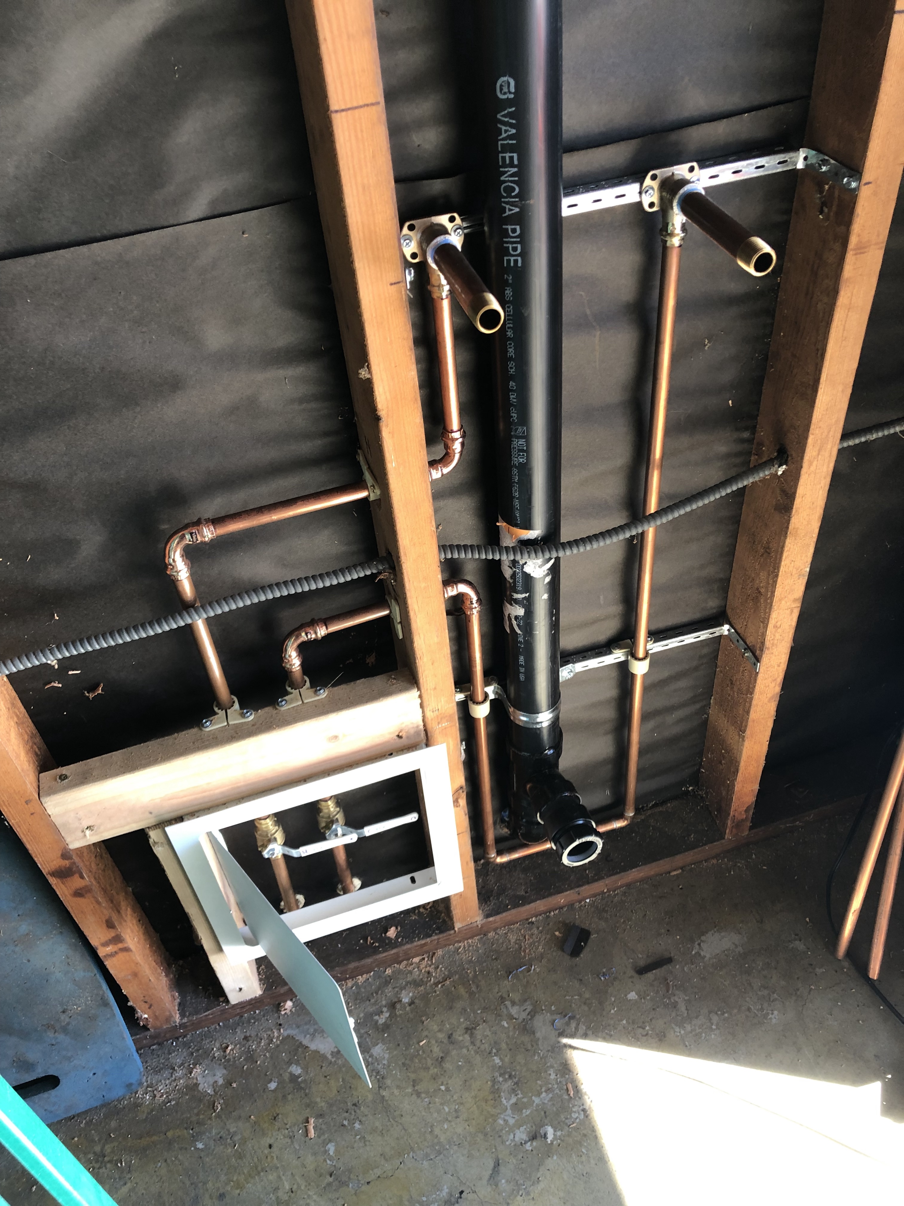 Kitchen sink drain lines, showcasing clean chrome and a p-trap, symbolic of plumbing and showcasing professional installation and maintenance services.