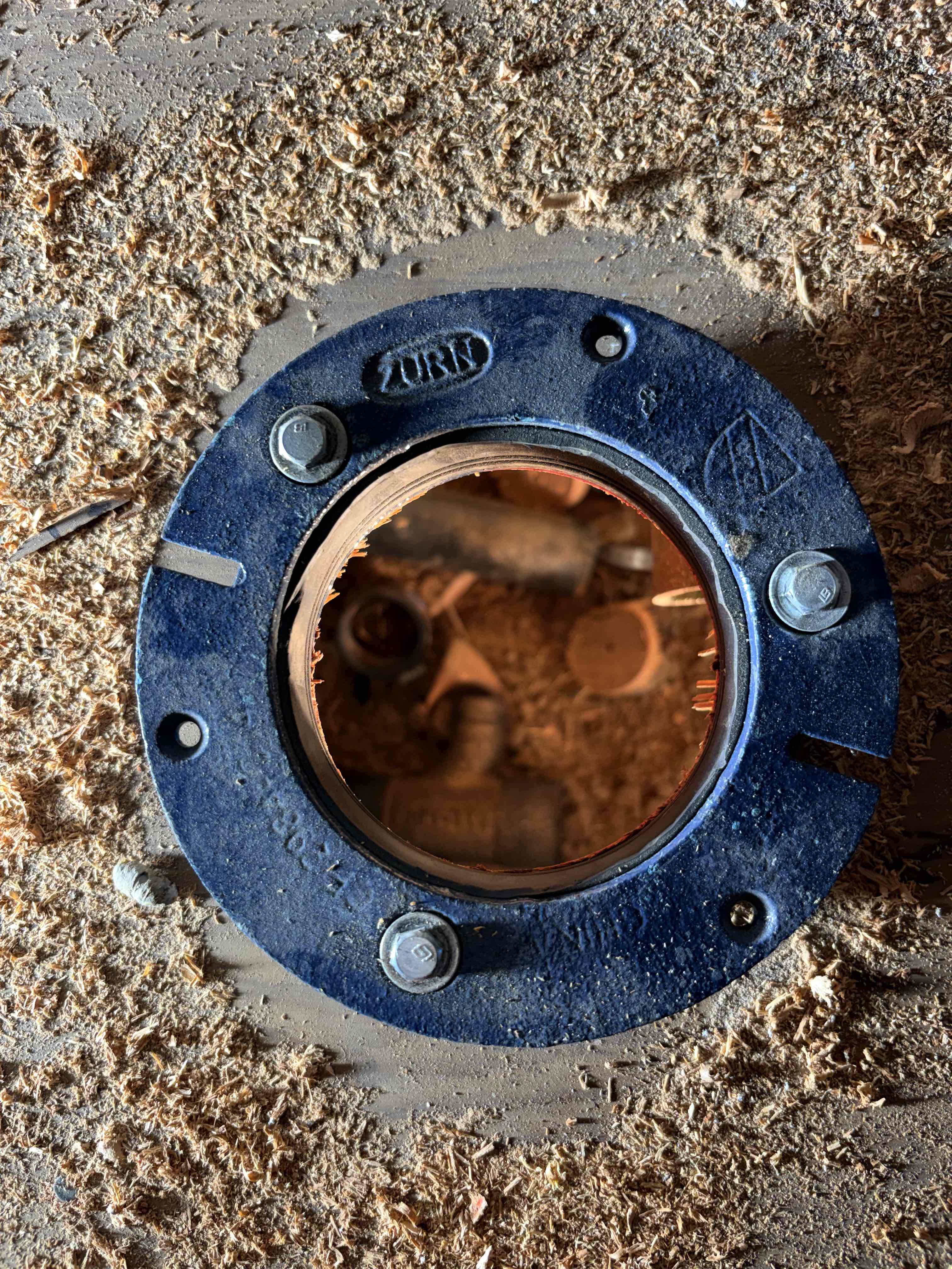 A modern bathroom featuring a glass-enclosed walk-in shower with rain showerhead on the left, a streamlined white toilet centered under a window, and a floating wooden-topped vanity with two vessel sinks and chrome faucets on the right.