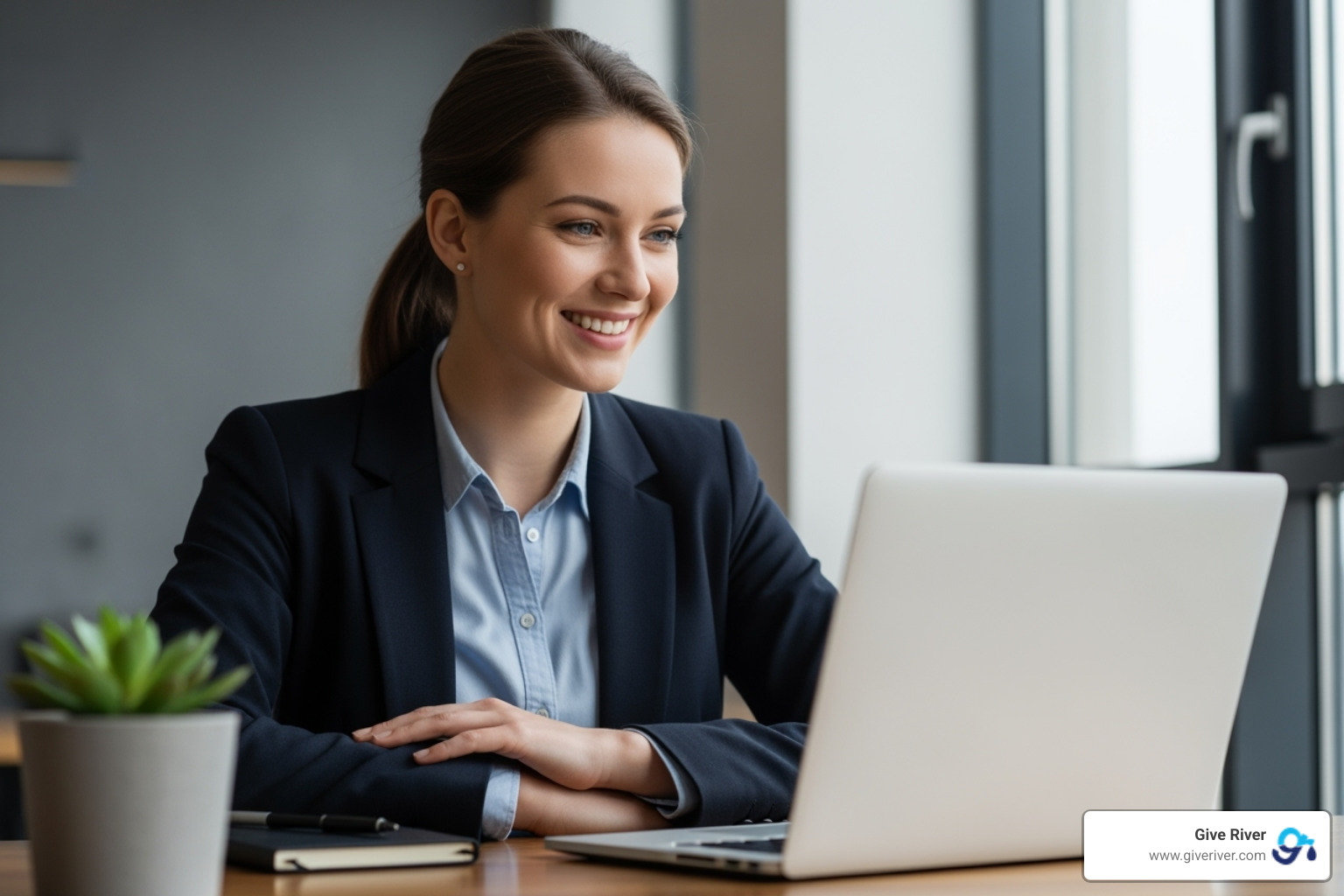 single employee smiling at their laptop, showing a sense of personal accomplishment - virtual team challenge games