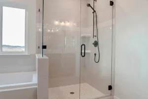 Frameless shower enclosure