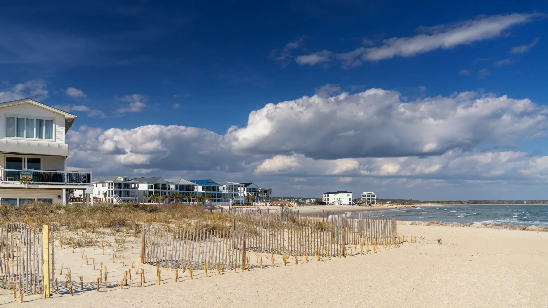 The north end of Ocean Isle Beach and Shallotte Inlet, North Carolina, under a blue sky