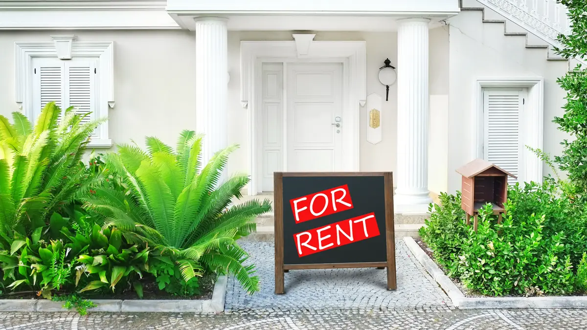 For Rent sign in front of a new house with a landscaped walkway