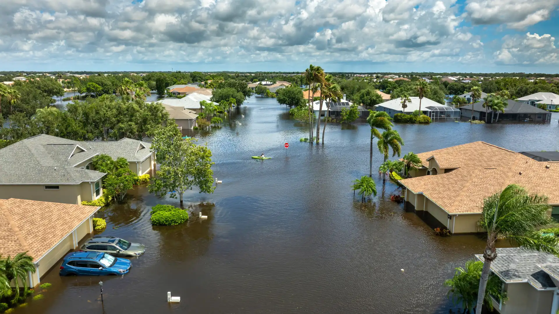 Aerial view of homes and cars in floodwater after a tropical rainstorm