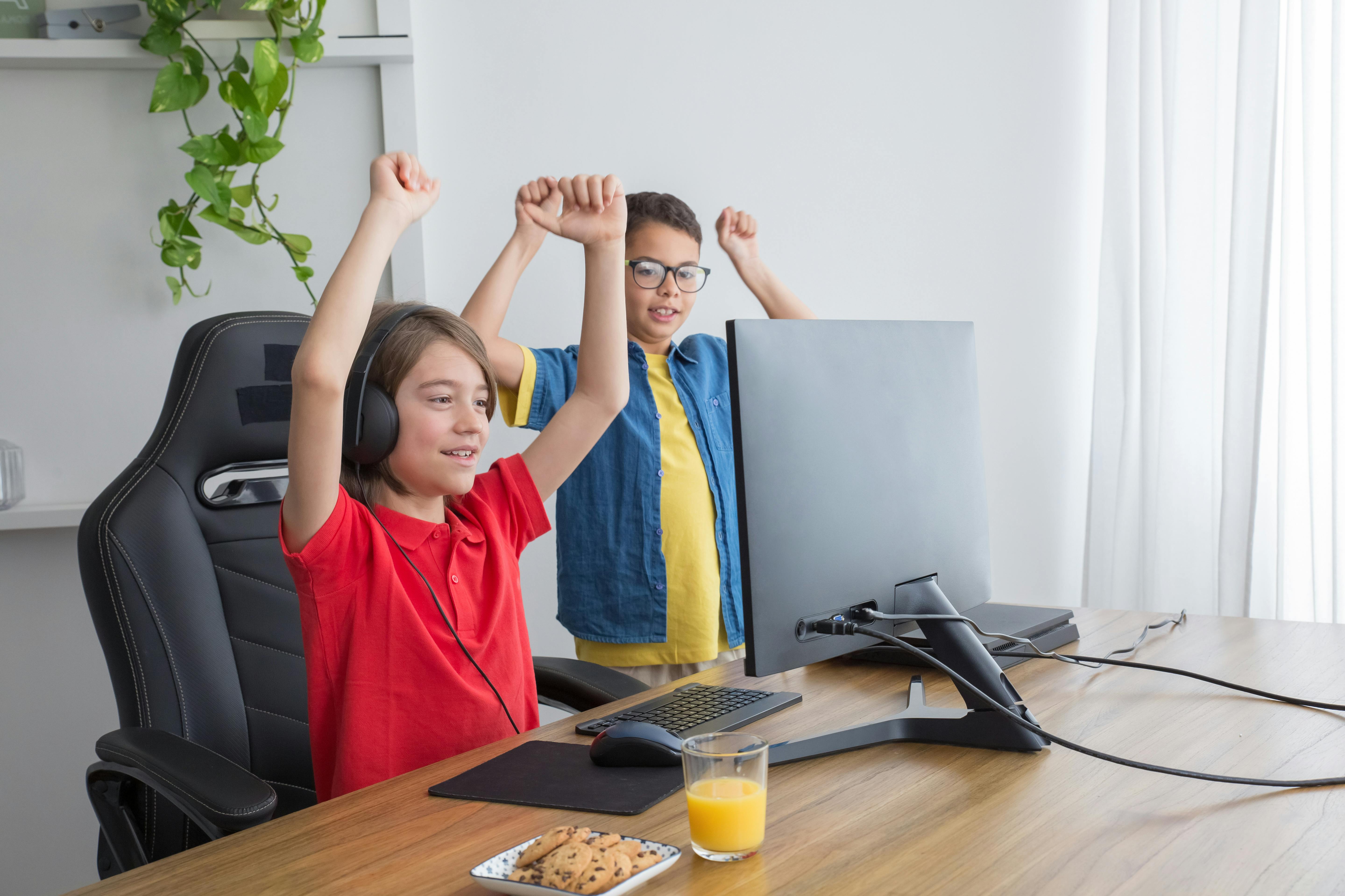 2 students are showing their excitement in front of the computer, they just accomplished something