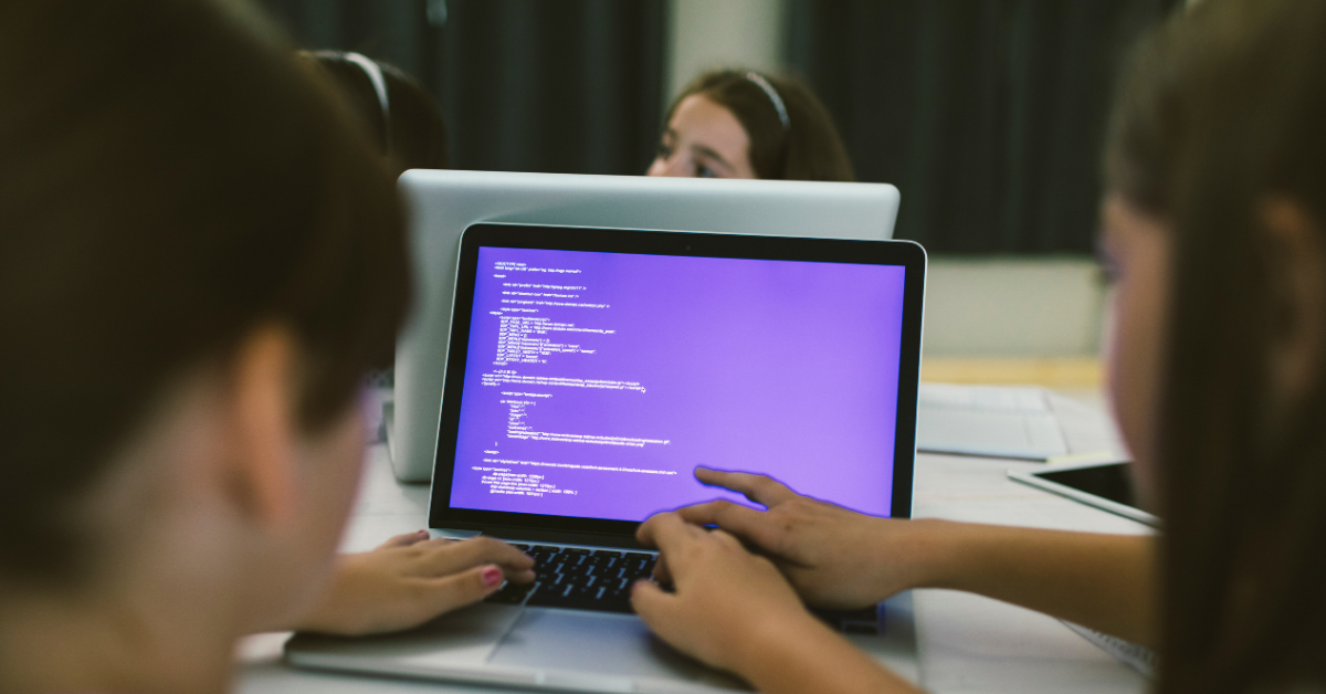 two kids coding on a laptop computer in an online coding course