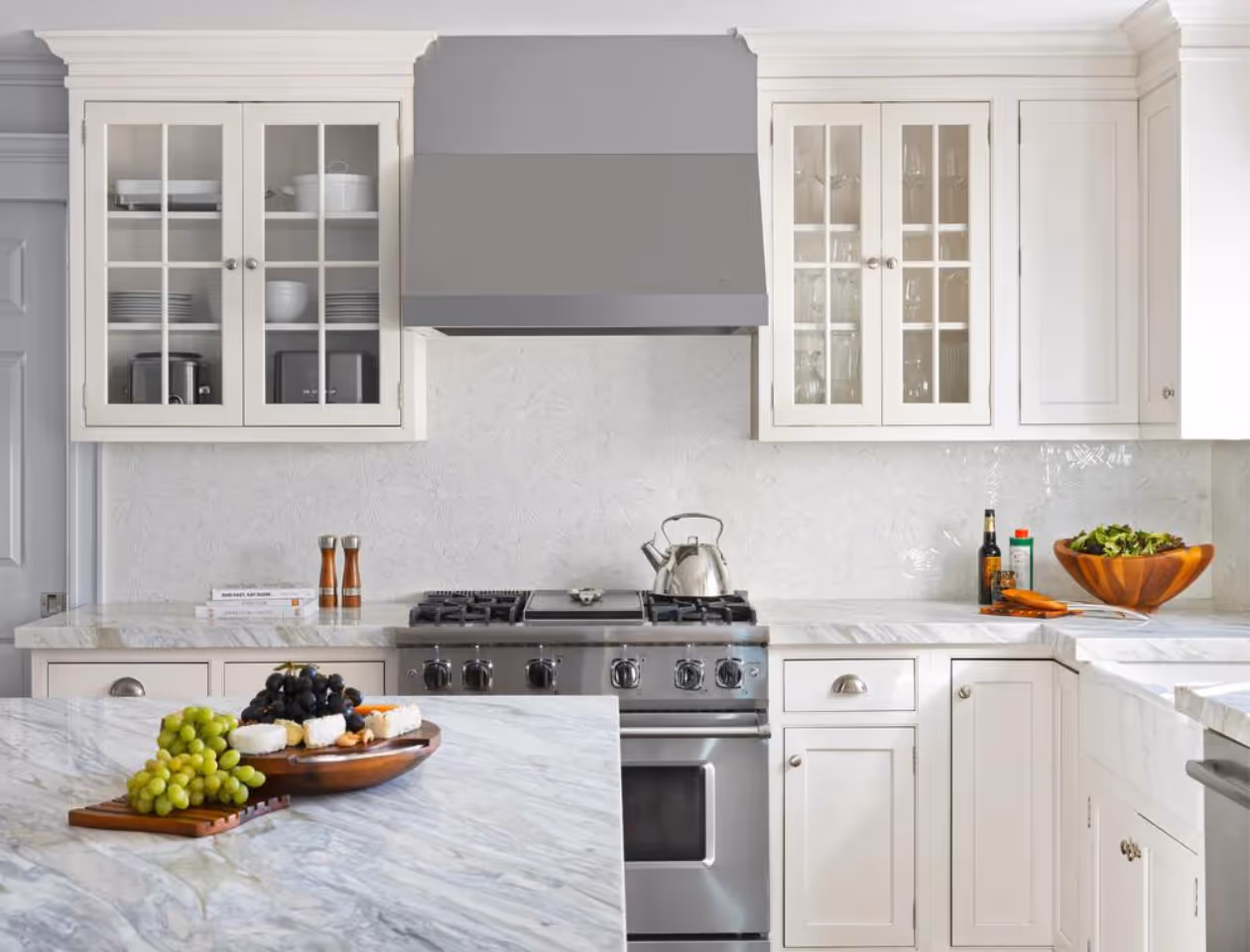 Stylish kitchen space featuring modern appliances and custom cabinetry by Stacy Nicole Interiors.- A kitchen with a marble countertop and stainless steel appliances. Stacy Nicole Interiors is a full-service North Carolina interior design firm. Luxury interior design in Charlotte-based at 1515 Mockingbird Lane, Suite 420, Charlotte, NC 28209. SouthPark luxury interiors.