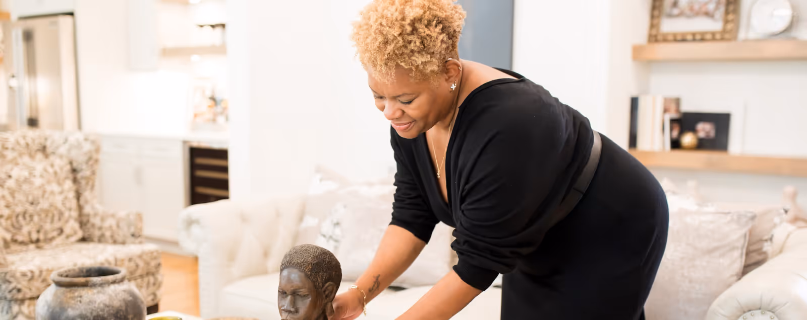 Nicole S Ingram, with a black shirt and a white bracelet, is holding a statue. Stacy Nicole Interiors is a full-service North Carolina interior design firm. Luxury interior design in Charlotte-based at 1515 Mockingbird Lane, Suite 420, Charlotte, NC 28209