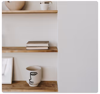 Residential Interior Design Services - A white framed picture of a face on a wooden shelf. Stacy Nicole Interiors is a full-service North Carolina interior design firm. Luxury interior design in Charlotte-based at 1515 Mockingbird Lane, Suite 420, Charlotte, NC 28209.