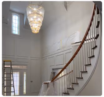 New Construction Interior Design Services- A white staircase with a white banister and chandelier. Stacy Nicole Interiors is a full-service North Carolina interior design firm. Luxury interior design in Charlotte-based at 1515 Mockingbird Lane, Suite 420, Charlotte, NC 28209.
